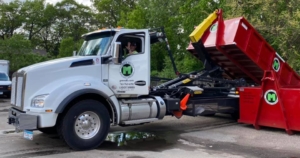 truck placing dumpster at a residential area